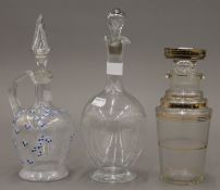 Three various glass decanters. The largest 30 cm high.