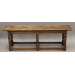 An oak bench stool. 137 cm long, 30.5 cm deep, 45 cm high.