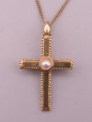 A 9 ct gold and seed pearl cross form pendant on chain. Cross 3 cm high, chain 41 cm long. 3.