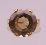 An unmarked gold citrine solitaire ring. Ring size I. 5.3 grammes total weight.