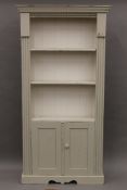 A modern white painted pine bookcase. 96.5 cm wide x 192 cm high.