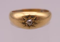 An unmarked gold gypsy set diamond solitaire ring. Ring size O. 3.1 grammes total weight.