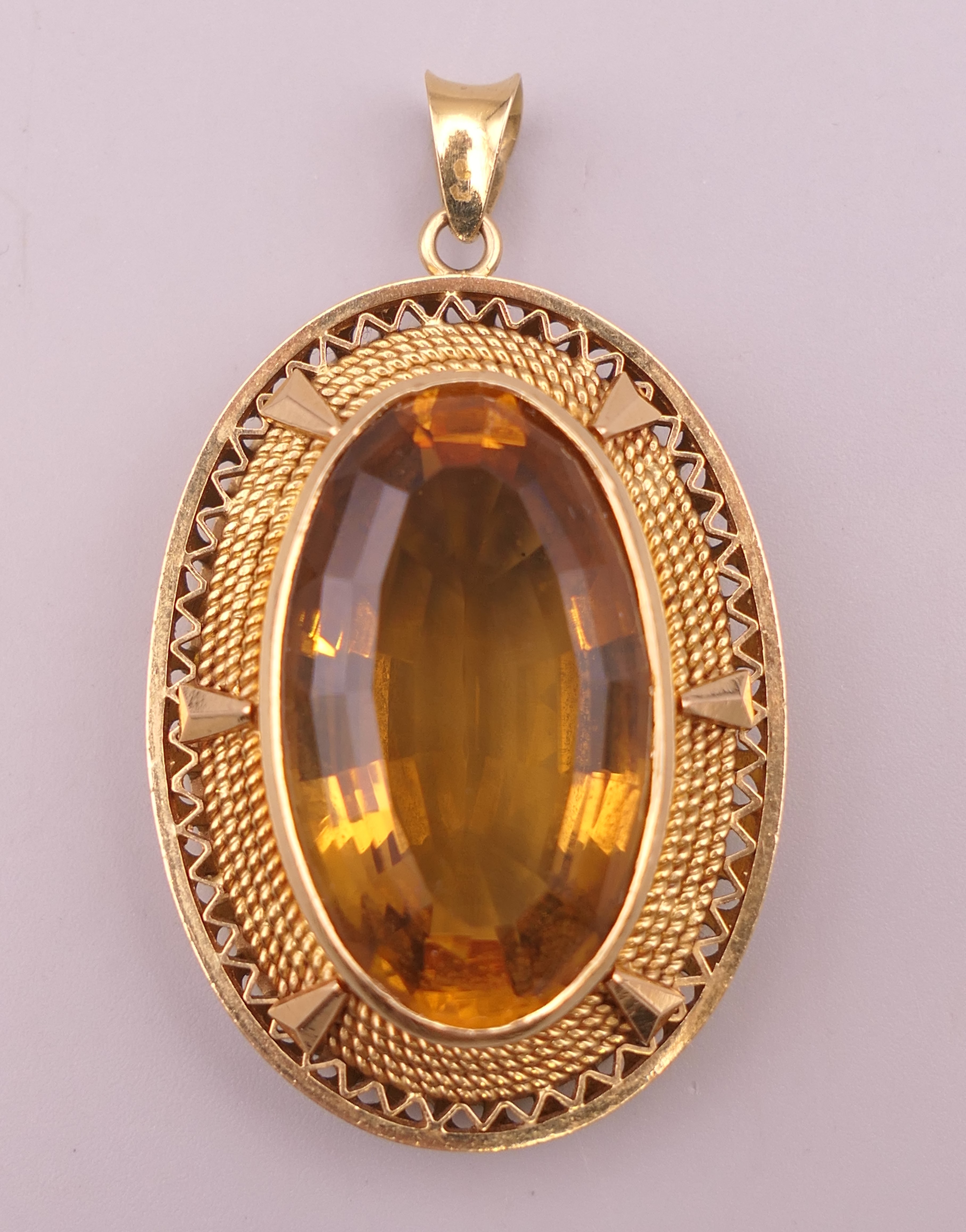 A large unmarked gold citrine pendant (tests as 15 ct plus gold). 5 cm high. 20.