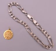 A silver bracelet and a 9 ct gold St Christopher pendant. Silver bracelet 20.5 cm long, pendant 1.
