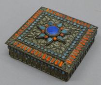 A Tibetan coral and turquoise set box. 8 cm square.