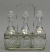 A three bottle decanter stand. 26.5 cm long.