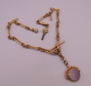 A gold plated fob on chain. Chain approximately 42 cm long, fob 2 cm diameter.