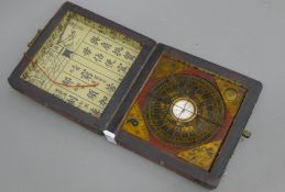 A Chinese compass in a lacquered box. The box 13.5 cm wide.