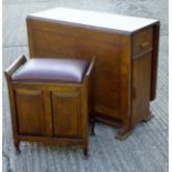 An early 20th century oak drop flap dining table and a piano stool.