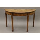 A 19th century mahogany demi lune side table. 114 cm wide.