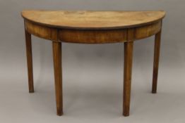 A 19th century mahogany demi lune side table. 114 cm wide.