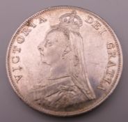 An 1887 silver coin. 3.5 cm diameter.
