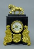 A Continental mantle clock surmounted with a bronze lion. 44 cm high.