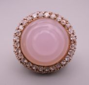 A silver gilt rose quartz ring. Setting approximately 3 cm diameter. Ring size P.