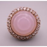 A silver gilt rose quartz ring. Setting approximately 3 cm diameter. Ring size P.