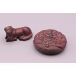 Two small carvings, one formed as a horse, the other faces. Horse 5 cm long, faces 5.5 cm diameter.