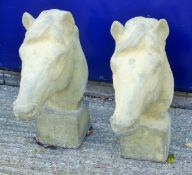 A pair of composition gate post horse head finials. Each 61 cm high.