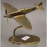A brass model of a spitfire. 21 cm wide.