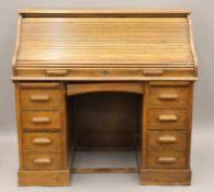 An early 20th century oak roll top desk. 121 cm wide.