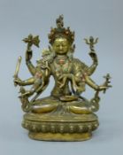 A gilt bronze multi-armed buddha decorated with coral and turquoise. 21.5 cm high.