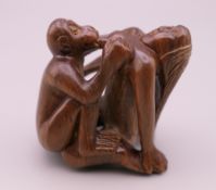 A wooden erotic netsuke. 4.5 cm high.