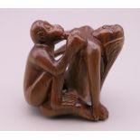 A wooden erotic netsuke. 4.5 cm high.