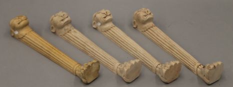 Four carved wooden table legs in the manner of Thomas Hope. 57.5 cm high.