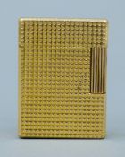 A gold plated S J Dupont gas lighter.