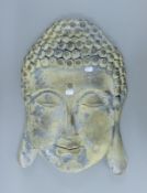 A rustic wall mounted buddha face. 57 cm high.