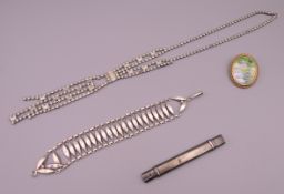 A silver bracelet, a silver pencil/letter opener, a brooch and a necklace. Bracelet 20 cm long.