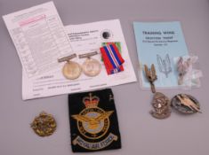 A collection of military badges and medals, including a Defence Medal and a 1939-45 War Medal,