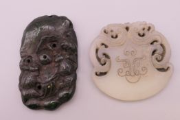 Two jade pendants. Largest 6 cm x 3.5 cm.