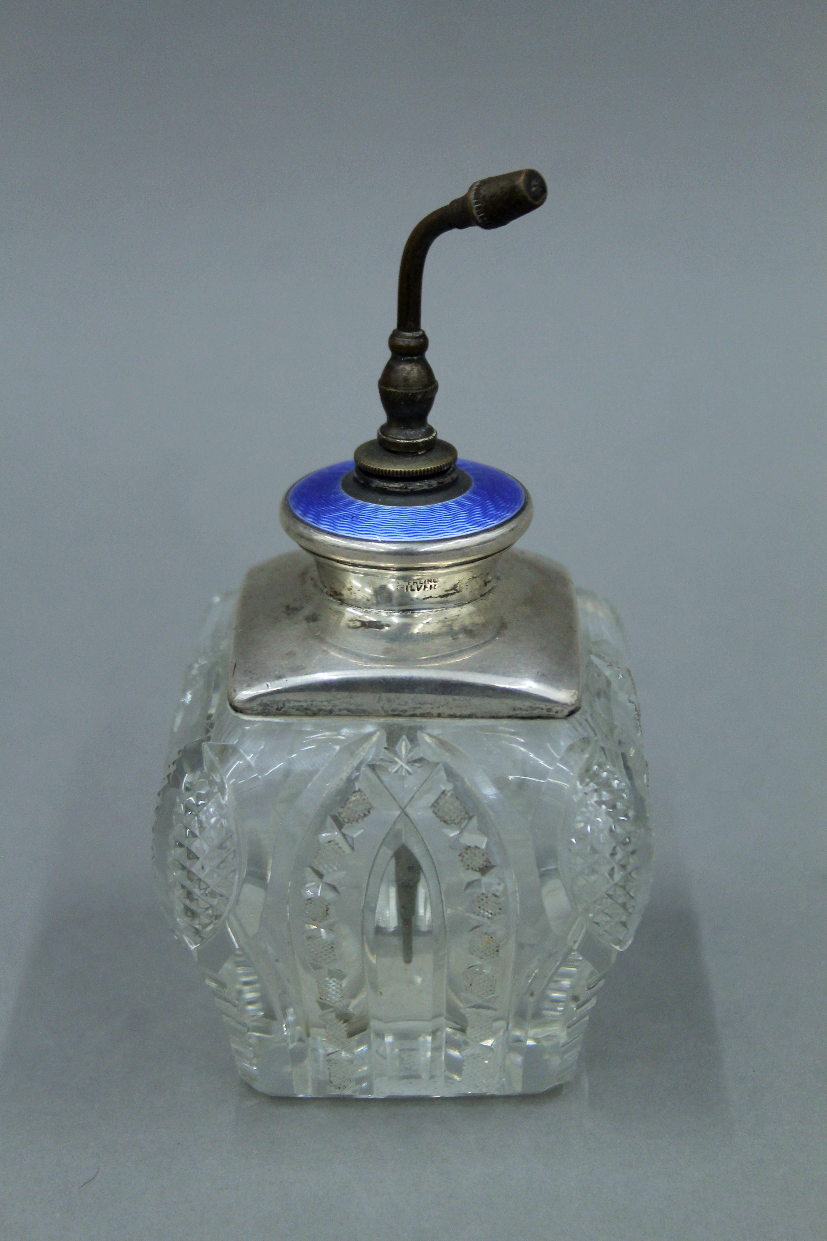 A sterling silver and blue enamel top cut glass atomiser. 15 cm high overall.