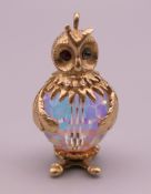 A 9 ct gold and crystal owl form charm. 3.2 cm high. 12.7 grammes total weight.