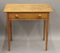 A 19th century pine single drawer table. 78 cm wide.