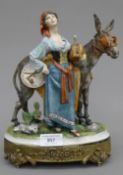 A Continental porcelain model a girl with a donkey.