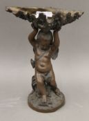 A 19th century patinated spelter cherub form centre bowl. 33.5 cm high.