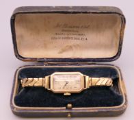 A Benson Ltd 9 ct gold cased ladies wristwatch. Watch case 2.5 cm x 1.5 cm.