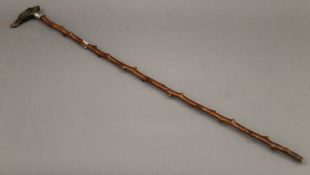 A walking stick with horn handle carved as a dog's head, set with a whistle. 90 cm long.