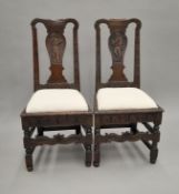 A pair of Georgian carved oak chairs. 47 cm wide.