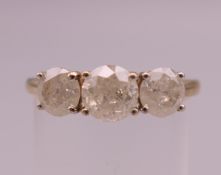 A 9 ct gold three stone diamond ring, the centre stone approximately 0.