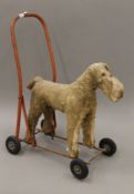 A vintage mohair child's push along dog toy. 42 cm long.