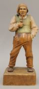A Dutch carved wooden figure of a man smoking a pipe. 29.5 cm high.