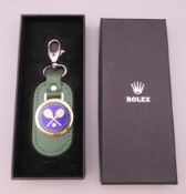 A Rolex Wimbledon key ring, boxed. 11 cm long including clasp.