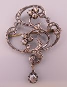 An antique diamond brooch/pendant with gold and silver setting. 5 cm high.