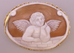 An 18 ct gold cameo brooch depicting cupid. 5.5 cm x 4 cm.