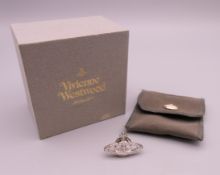 A boxed Vivienne Westwood pin brooch. 2.6 cm x 1.6 cm.