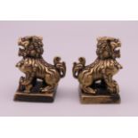 A pair of small gilt bronze Chinese seals formed as dogs-of fo. Each 3 cm high.