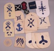 A collection of military cloth badges.