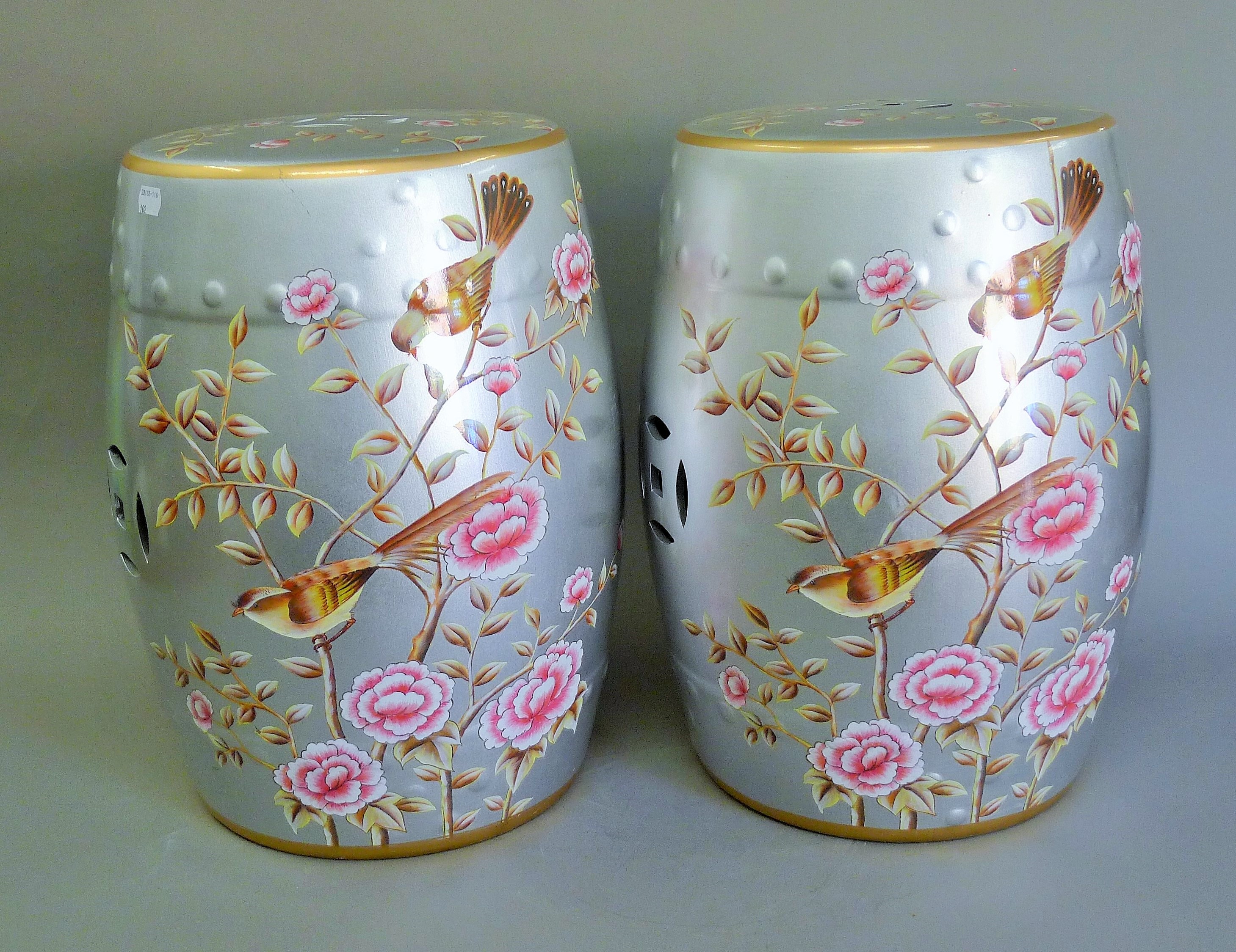 A pair of silvered barrel stools decorated with birds. 45 cm high.